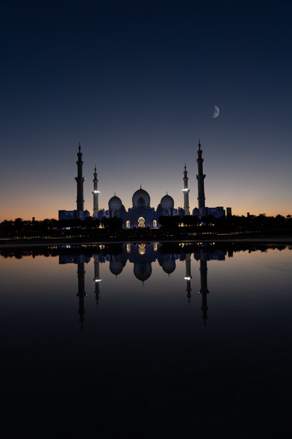 Sheikh Zayed Grand Mosque at dusk with reflection